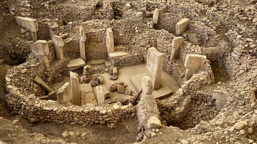 an aerial view of a building with ruins and pillars