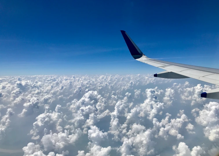 view from an airplane of clouds and a blue sky