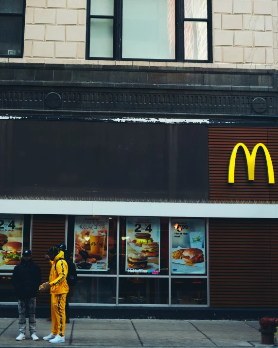 two people in costumes look at menus outside a mcdonald's