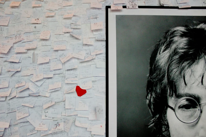 a portrait of john lennon surrounded by pins