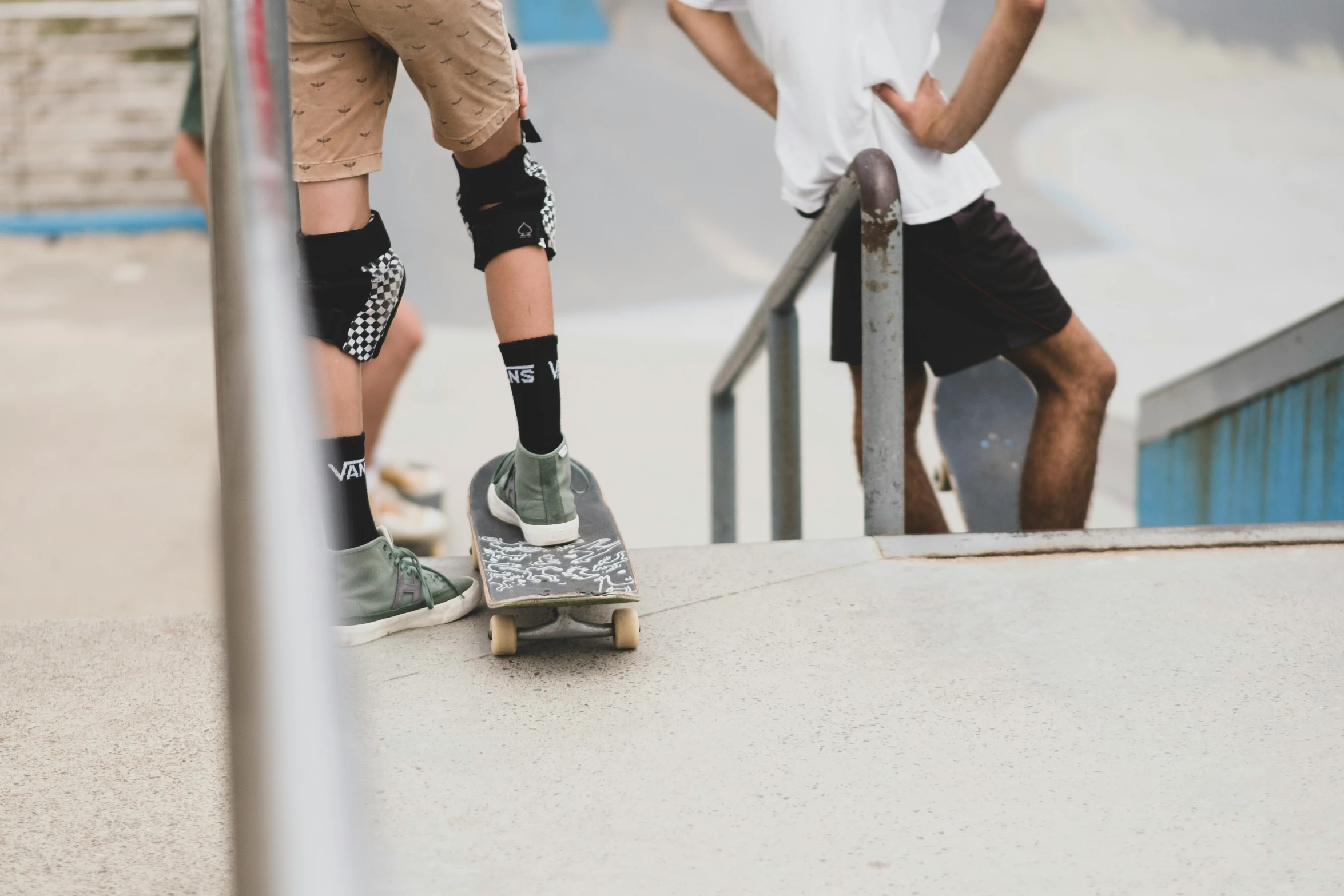 two boys with skateboards are at a ramp