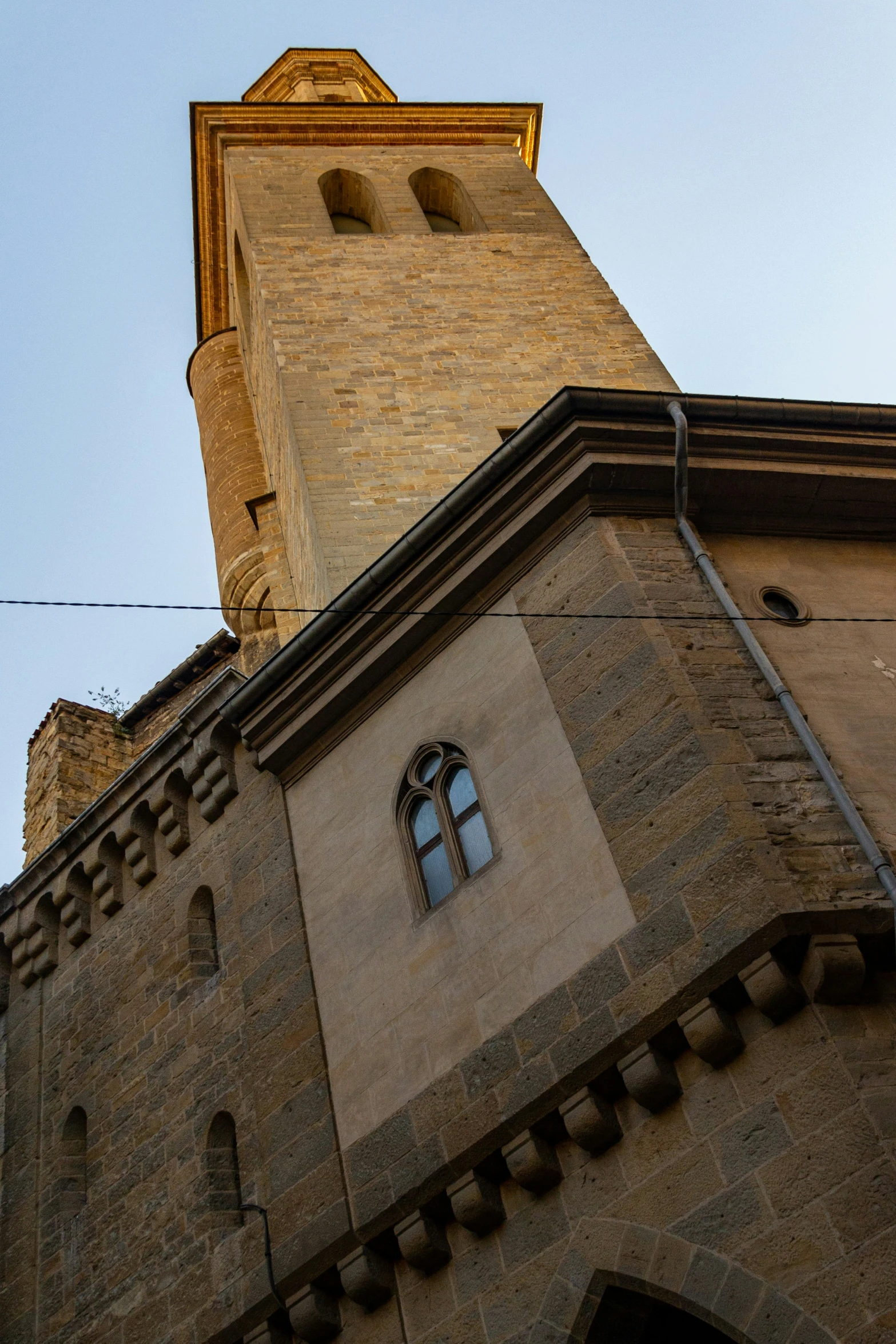 the outside of an old building, with a sky view looking up