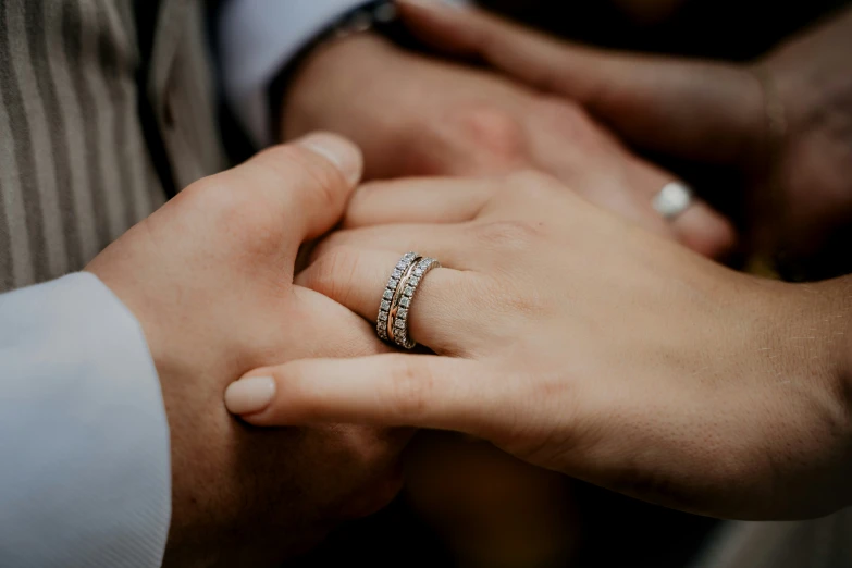 a couple is holding hands holding the other hand