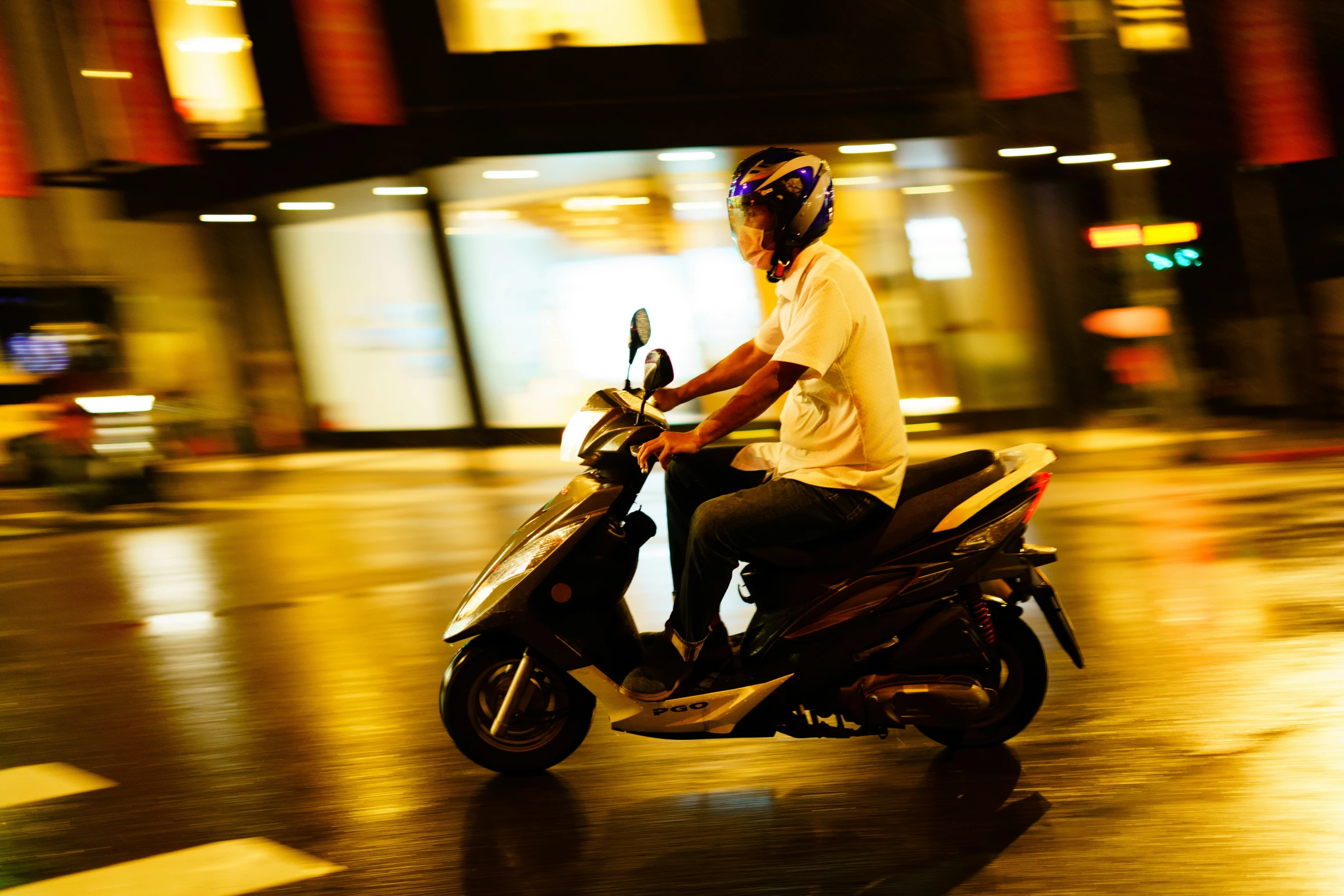 a man rides on his motorcycle in the middle of the city