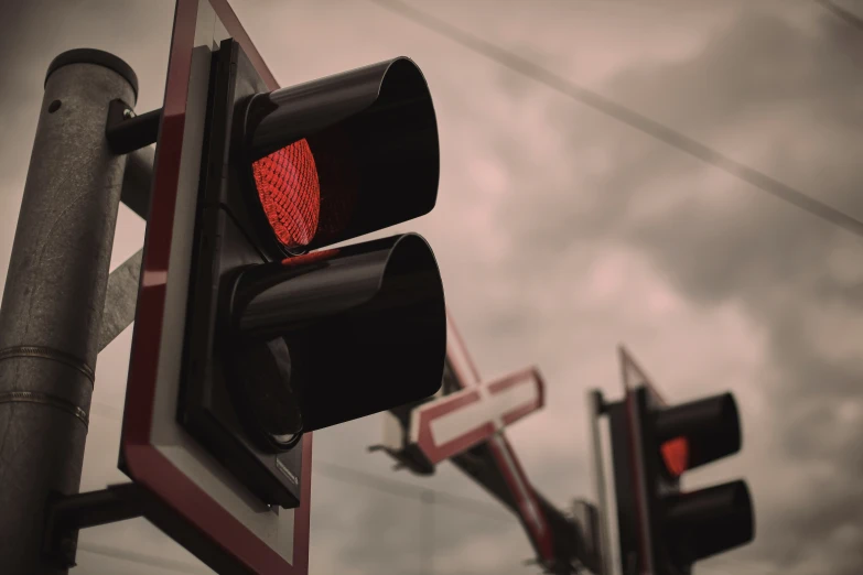 a red traffic light sitting above a traffic sign