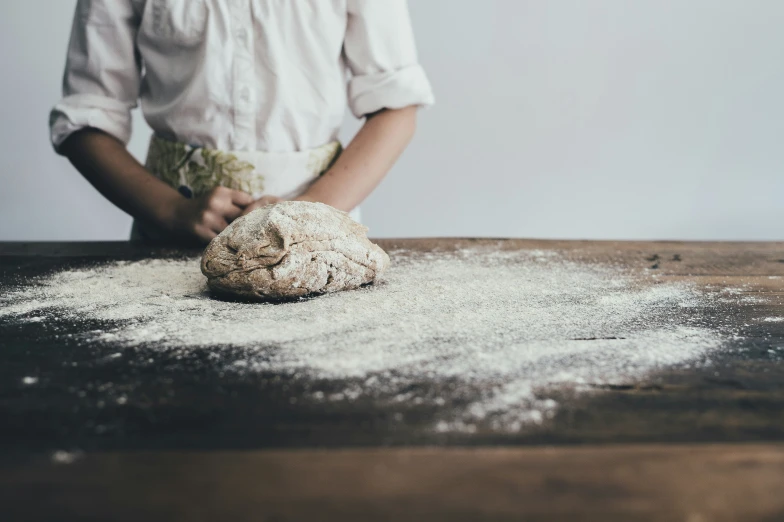 a person wearing a shirt in front of flour