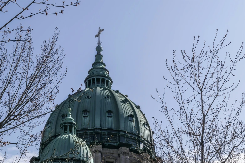 a large building has a pointed clock on it