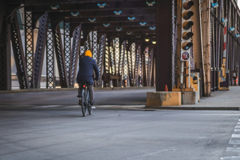 the person is on a bicycle crossing a street