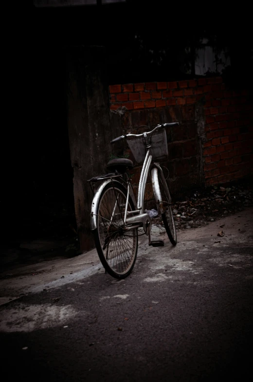 an old bicycle is sitting on the street in the dark