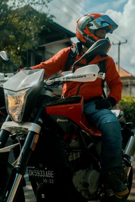 a person sitting on top of a red motorcycle