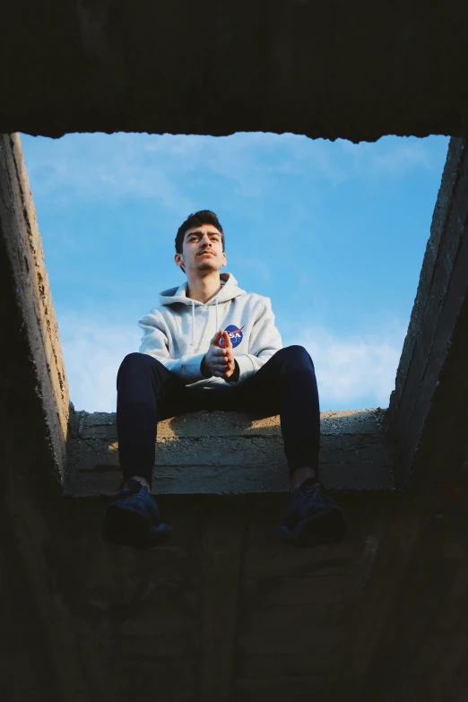 the man is sitting in a wooden structure