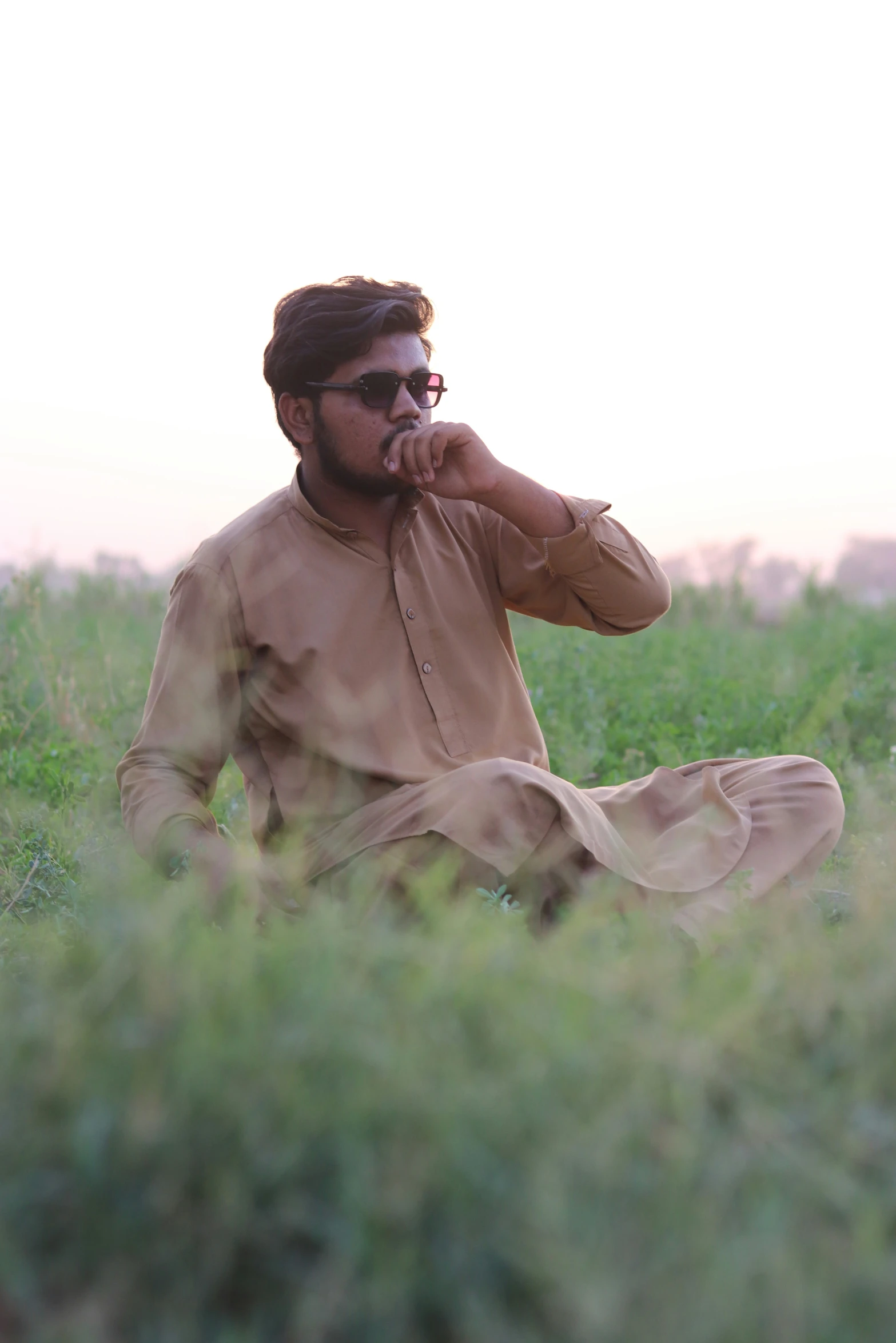 a man sitting on the ground and eating