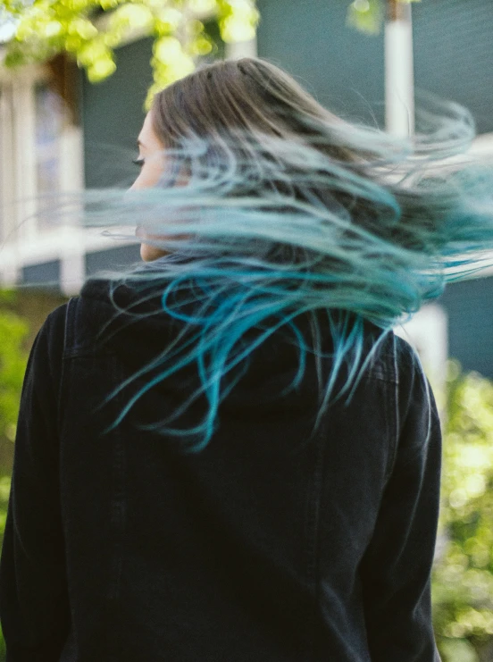 a woman with her hair blowing in the wind