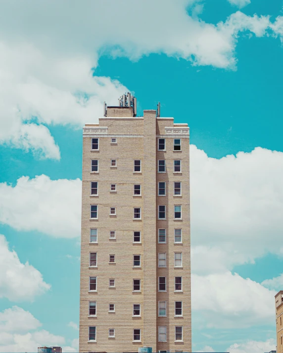 the top of the tall brick tower building with a clock