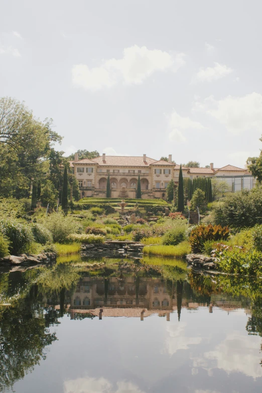 there is a building that sits in the distance near a pond