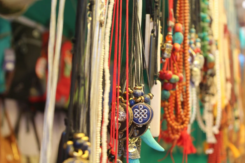 colorful beads are hanging up on the wall