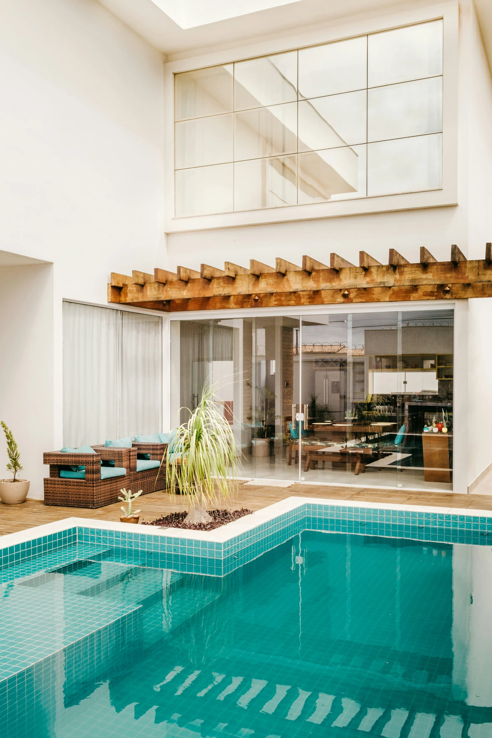 an indoor pool with a patio and dining area