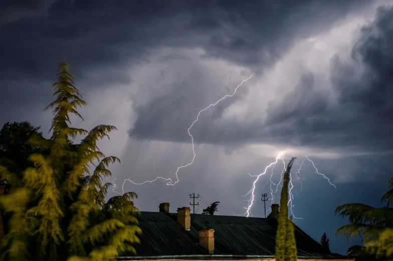 the lightning has struck over the home in the distance