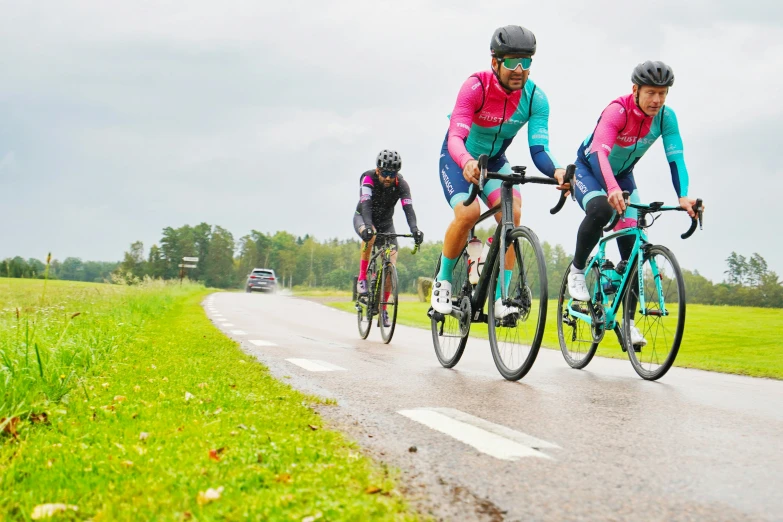 two men riding their bikes down the road