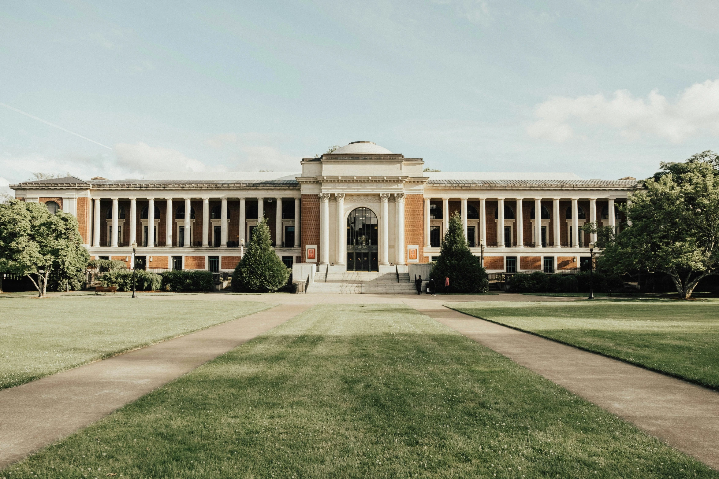 a large building sitting on top of a lush green field