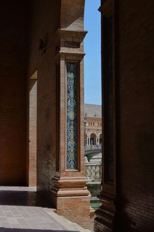 a pillar is lined with a decorative window and pillars