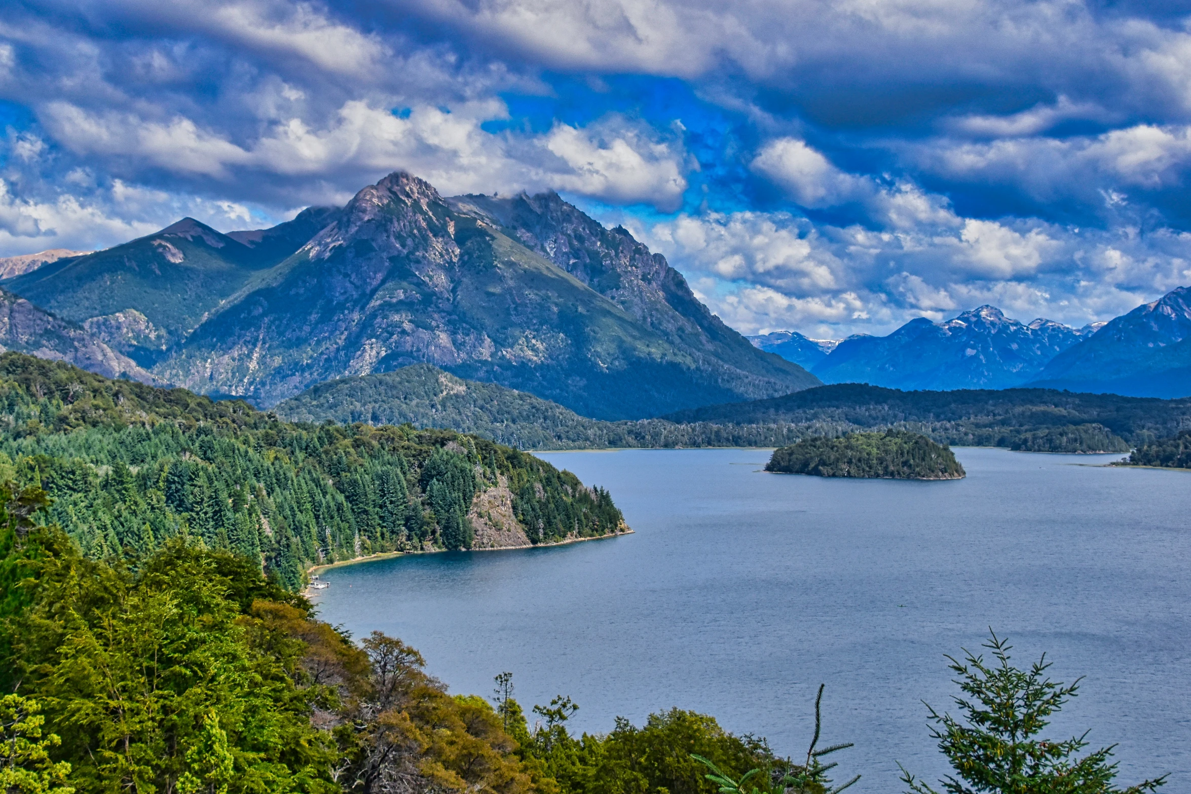 a very wide open body of water in the middle of a mountainous area