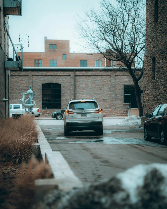 a car on a street next to an old brick building