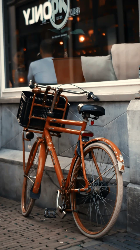 a bike parked outside of a restaurant on the street