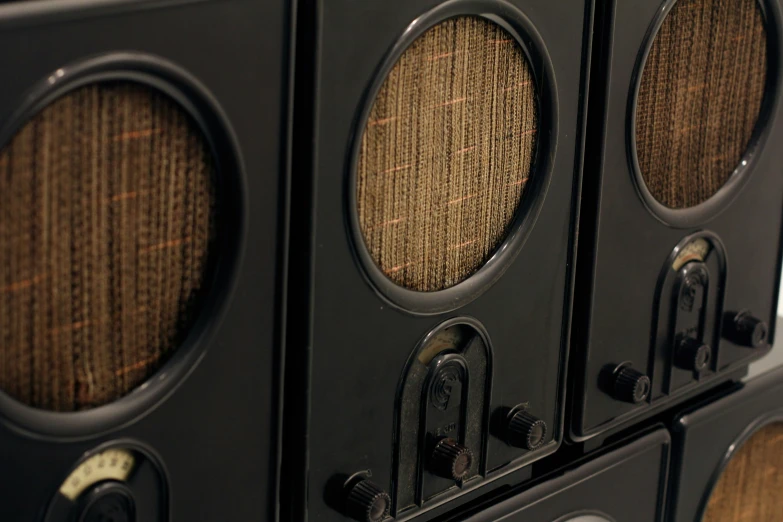 an old style, black radio with three different color dials