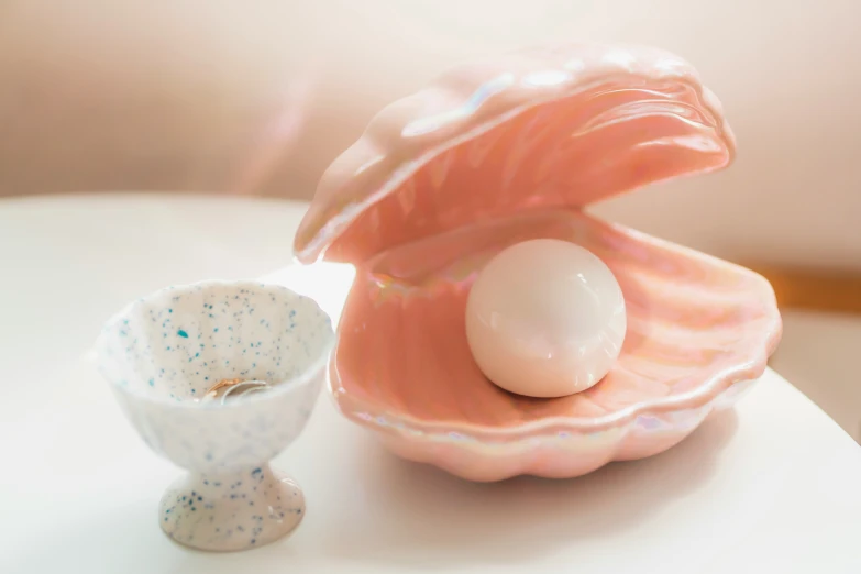 an egg is inside a shell next to a small container