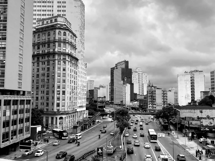 black and white picture of cars and a highway in a city