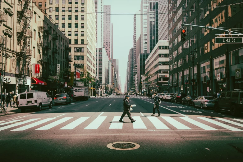 a person crossing an intersection in the city