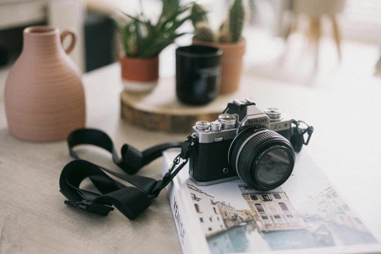 camera and a strap on a table