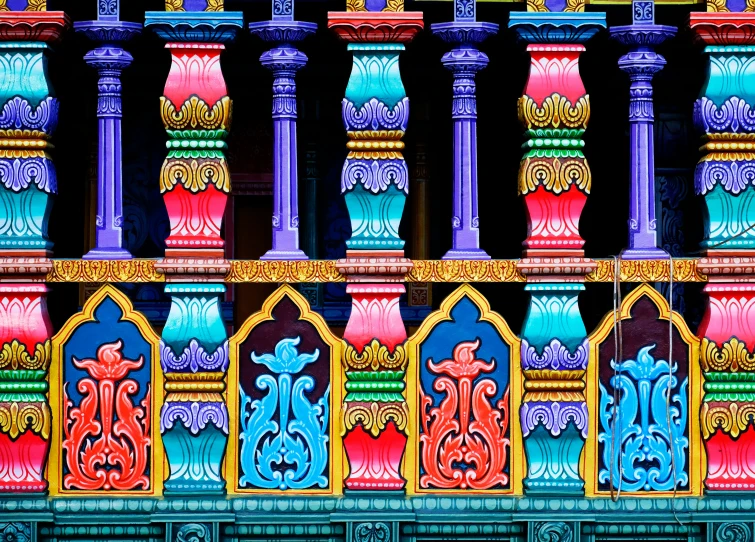 an intricately colored building with columns and windows