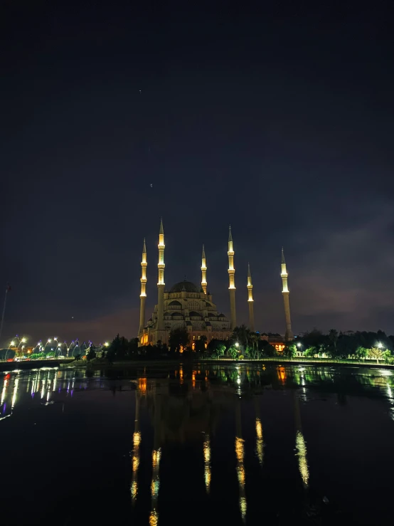 the lights on this building reflect off the water