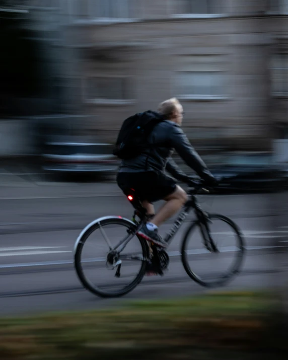 a bicyclist in motion along a city street