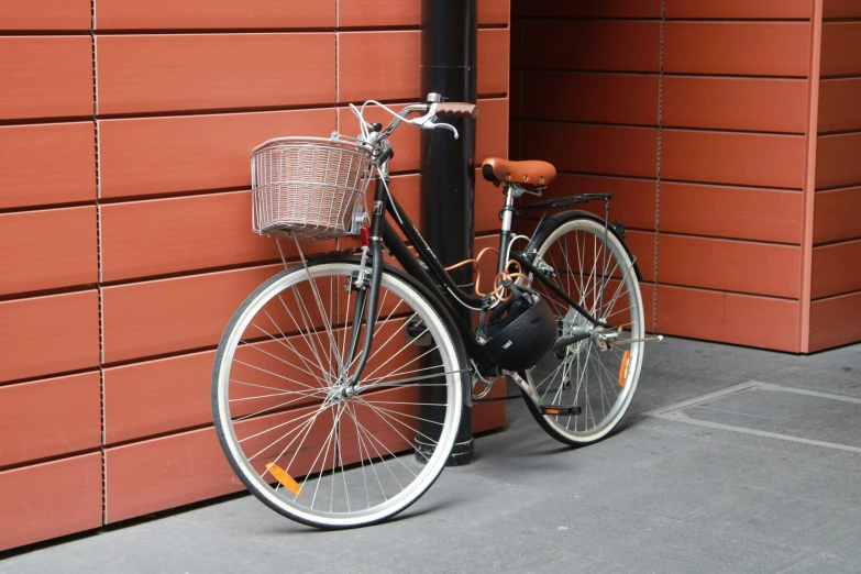 there is a bicycle leaning on the brick wall