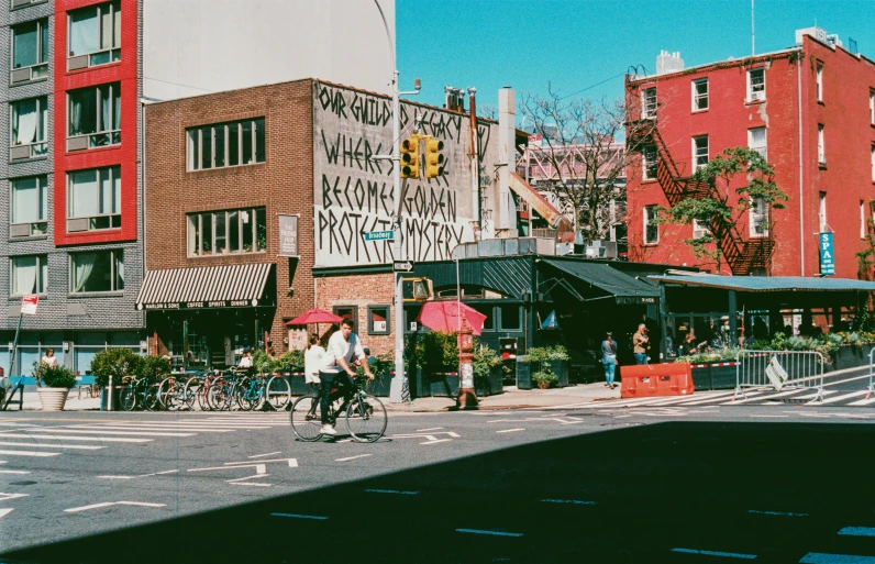 pedestrians crossing the street on a sunny day