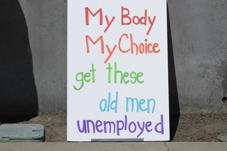 sign written in multiple colors that reads my body, my choice, get these old men unemported