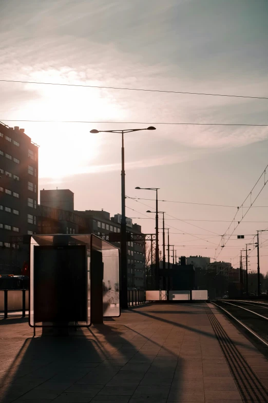 the sun is just peaking over the horizon on a train track