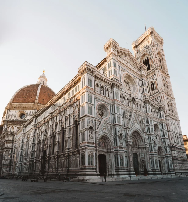 this large cathedral has a stone facade and is surrounded by statues and sculptures