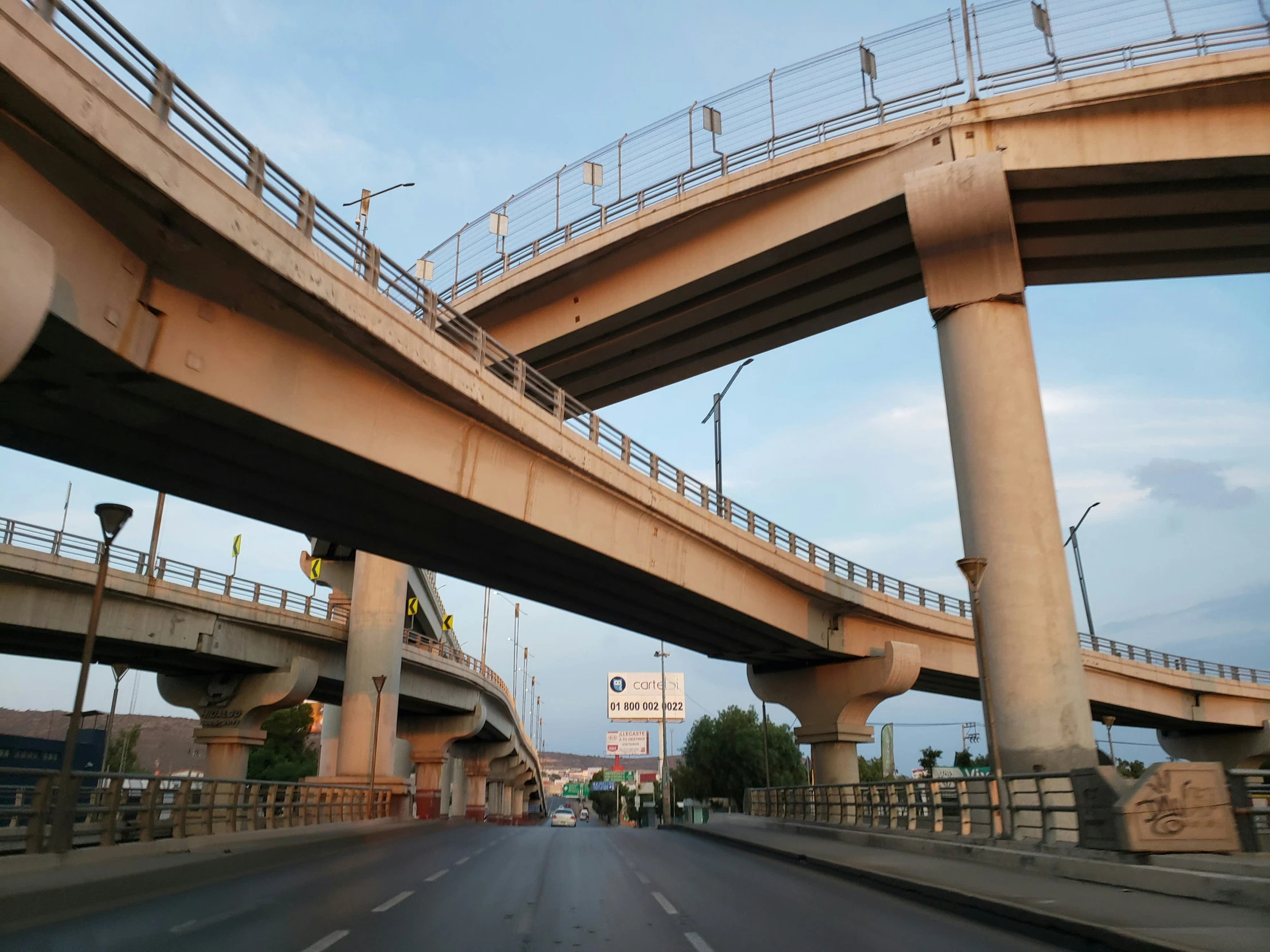 a road going under an overpass to a freeway