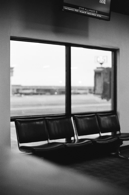 a waiting area has an airplane out the window