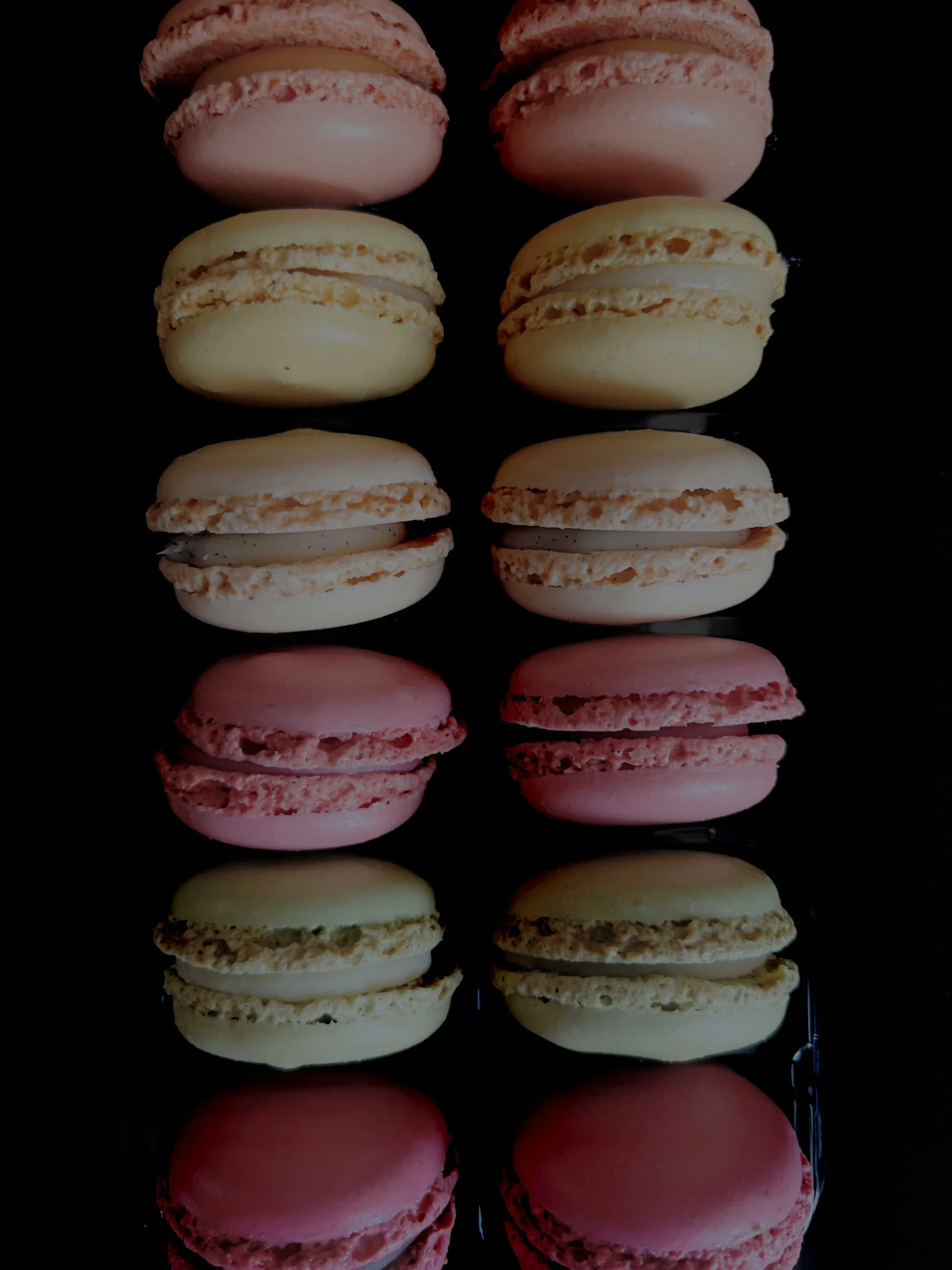 several macarons are arranged in rows on a plate