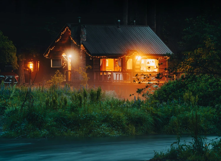 a house is lit up with christmas lights at night