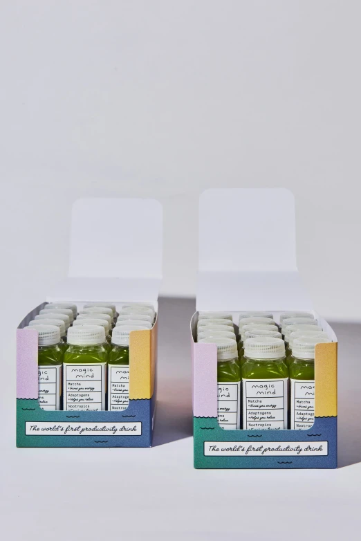 a set of two boxes with some green juice in them