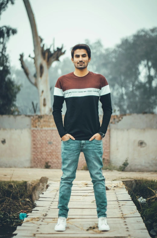 a man standing on a wooden plank over water