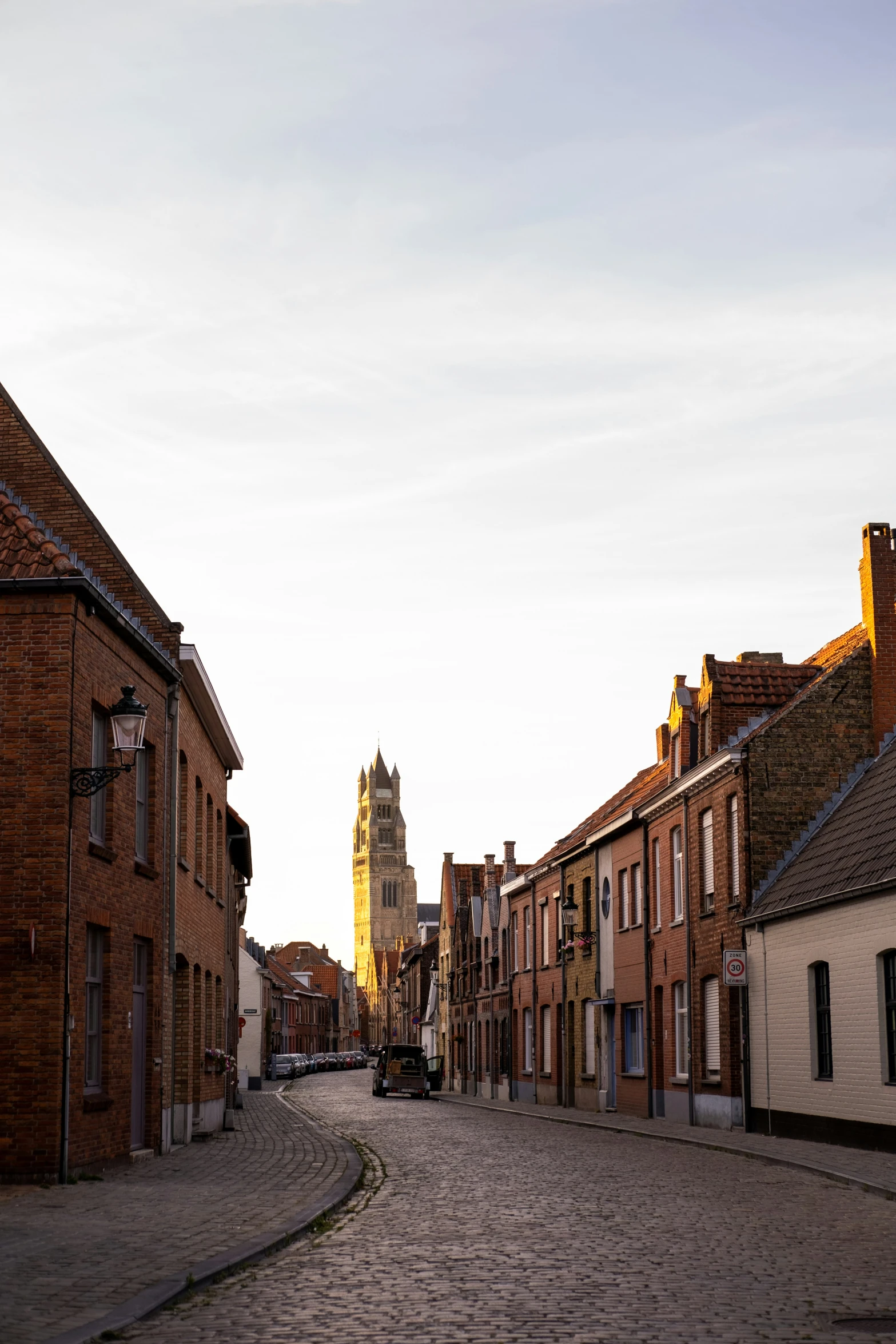 an old street with buildings and a clock tower