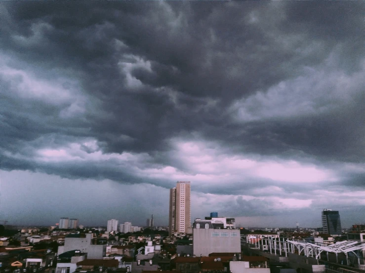 the city is covered by grey clouds in this view