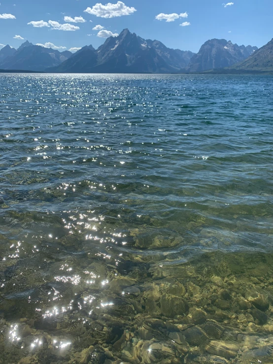 there is some water under the clouds near mountains